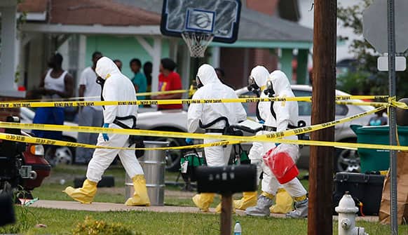 Federal authorities wearing hazmat suits walk to the home of Everett Dutschke for additional investigation, in Tupelo, Miss., in connection with the recent ricin attacks. No charges have been filed against Dutschke and he hasn’t been arrested.