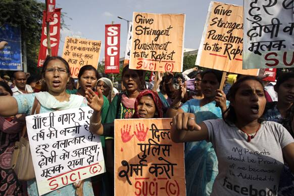 Protestors shout slogans as they hold placards demanding stringent punishment to rapists during a protest in New Delhi.