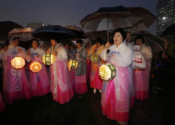 Buddhist believers holding lanterns attend an event to celebrate the upcoming birthday of Buddha in Seoul, South Korea.