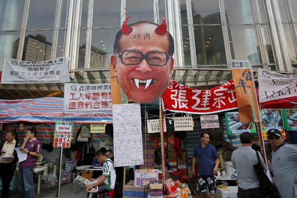 A defaced portrait of Hong Kong billionaire Li Ka-shing is placed outside Li`s headquarters, Cheung Kong Center during a protest in Hong Kong.
