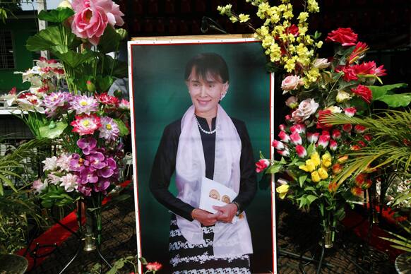A portrait of Myanmar opposition leader Aung San Suu Kyi decorated with flowers is displayed at an opening ceremony of a branch office of her National League for Democracy party, in Yangon, Myanmar.
