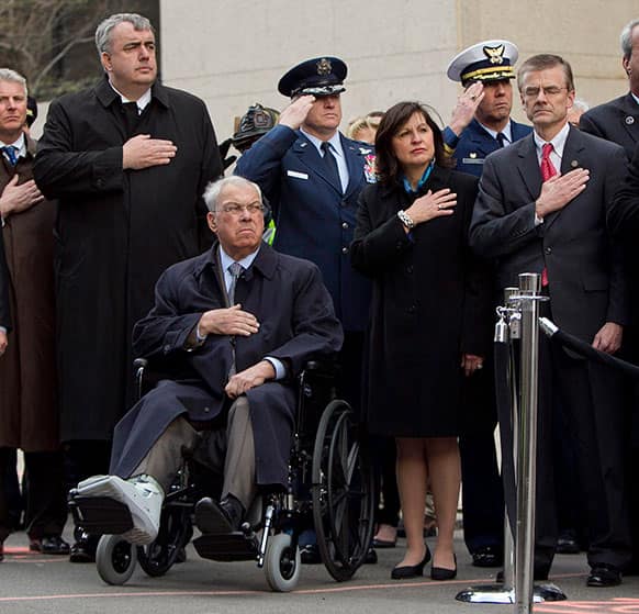 Boston Police Commissioner Edward Davis, left, Boston Mayor Thomas Menino, seated, US Attorney Carmen Ortiz, second from right, and Special Agent in Charge of the FBI`s Boston Field Office Richard DesLauriers, right, salute the American flag during a ceremony at the blast site.