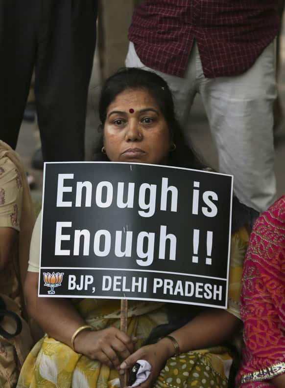Woman holds a placard during a protest to demand for tougher rape laws and better police protection for women, outside the Parliament in New Delhi.