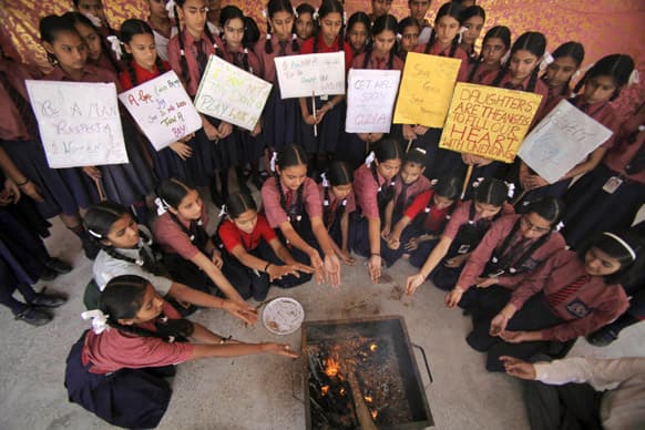 Schoolgirls perform rituals as they offer prayers for the speedy recovery of a 5-year-old girl who was raped and tortured in New Delhi, at Dewan Devi Public School in Jammu.