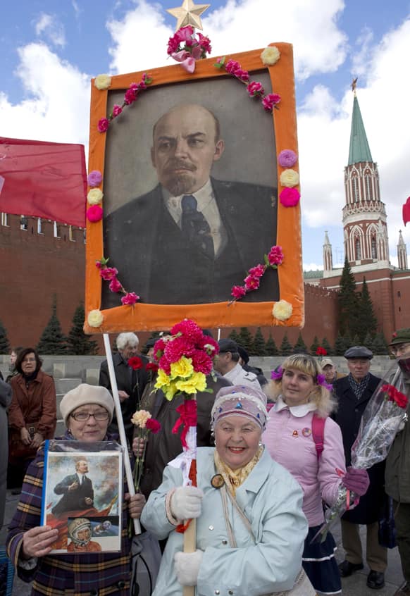 Russian communists and supporters gather in Red Square, with their flags and portraits of Lenin, to visit the Mausoleum of the Soviet founder Vladimir Lenin to mark the 143th anniversary of his birth in Moscow.