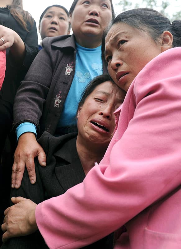 A woman cries for her relatives who were killed in an earthquake during a funeral in Longmen village in Lushan county in southwest China`s Sichuan province.