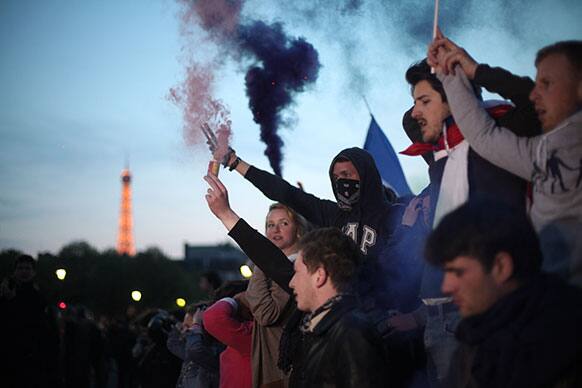 Demonstrators burn flares during a rally to protest against French President Francois Hollande`s social reform on gay marriage and adoption in Paris.