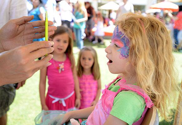 Tulia Temple, 5, of Glendale reacts to her face paint at the Earth Day Celebration at The Americana at Brand in Glendale, CA benefitting Philippe Cousteau’s EarthEcho.