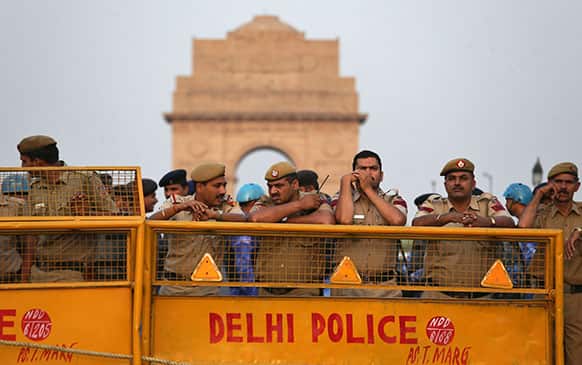 Indian policemen stand behind barricades to block protesters against the rape of a 5-year-old girl near the India Gate monument in New Delhi.
