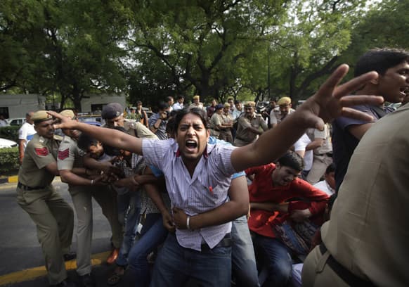 Policemen try to remove protestors shouting slogans outside Prime Minister`s residence during a protest against the rape of a 5-year-old girl in New Delhi.