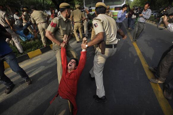 Policemen drag a protestor after detaining him outside Prime Minister`s residence during a protest against the rape of a 5-year-old girl in New Delhi.