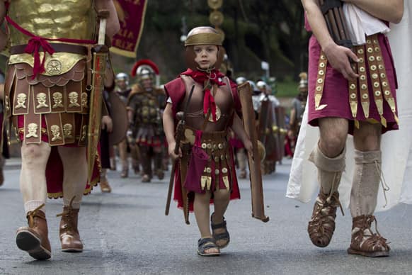 Ancient Roman costumed people parade in the ancient areas of Colosseum, Circus Maximus and the Roman Forum to celebrate the festivities of Christmas of Rome.