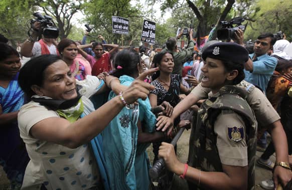 Women activists of India`s main opposition Bharatiya Janata Party are stopped by police near the residence of ruling Congress party president Sonia Gandhi during a protest against the rape of a 5-year-old girl in New Delhi.