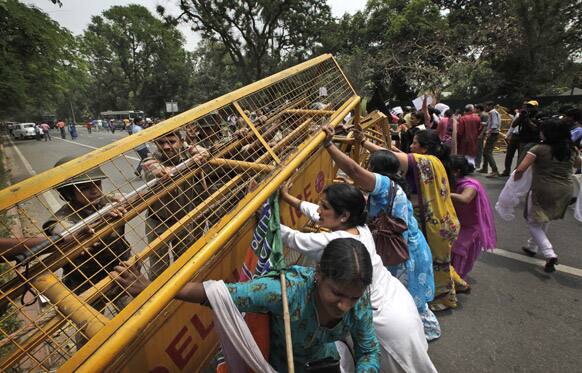 Women activists of India main opposition Bharatiya Janata Party remove police barricade outside ruling United Progressive Alliance chairperson Sonia Gandhi’s residence during a protest against the rape of a 5-year-old girl in New Delhi.