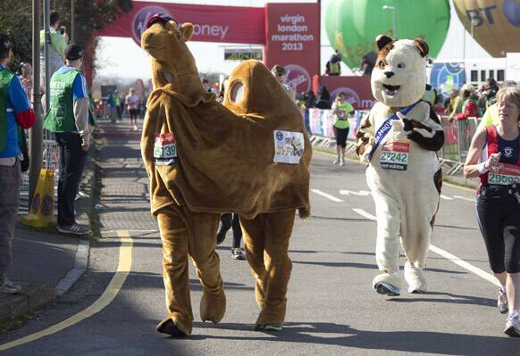 Fun runners dressed as a camel and a dog, set off at the start of this year`s Virgin London Marathon, at the Green Start Line, in Greenwich Park, east London.