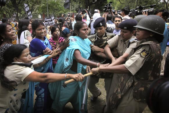 Delhi police women try to stop women activists of India main opposition Bharatiya Janata Party outside ruling United Progressive Alliance chairperson Sonia Gandhi’s residence during a protest against the rape of a 5-year-old girl in New Delhi.