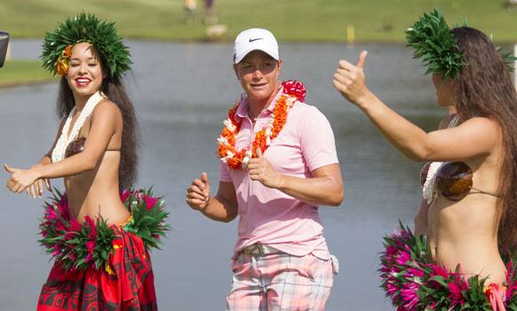 Suzann Pettersen of Norway attempts to dance the hula after winning the 2013 LPGA Lotte Championship golf tournament at the Ko Olina Golf Club.