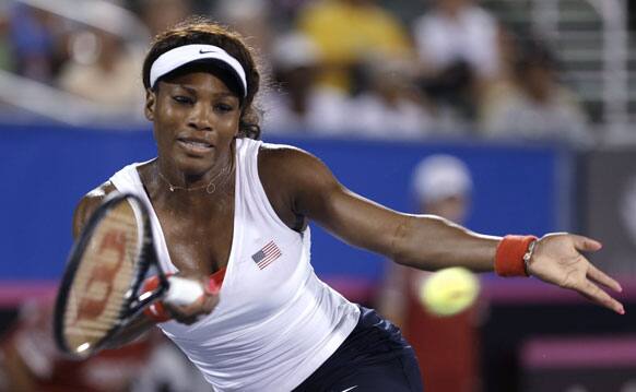 Serena Williams, of the United States, returns to Johanna Larsson, of Sweden, during a Fed Cup World Group Playoff tennis match in Delray, Beach, Fla.