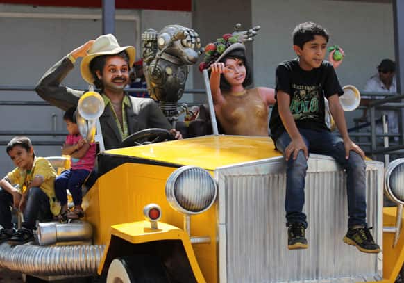 Children pose for photographs with the Mr. India exhibit at the Adlabs Imagica theme park in Sangewadi some 62 miles south-east of Mumbai.