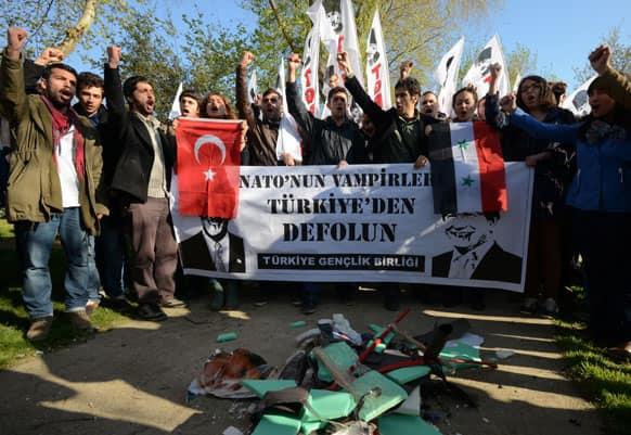 Turks shout slogans with destroyed effigies of U.S. Secretary of State John Kerry and his Turkish counterpart Ahmet Davutoglu as the