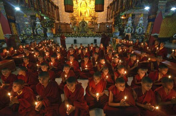 Young Buddhist monks pray for the speedy recovery of a 5-year-old girl who was raped and tortured in Delhi, in Bodhgaya.