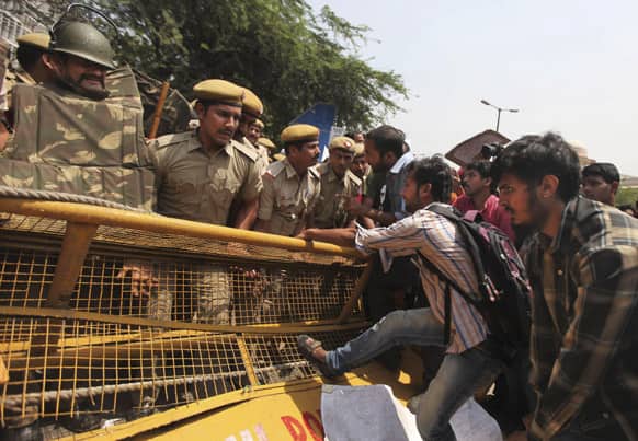 Protesters try to pull down a police barricade outside the Delhi Police headquarters during a protest against the rape of a 5-year-old girl in New Delhi.