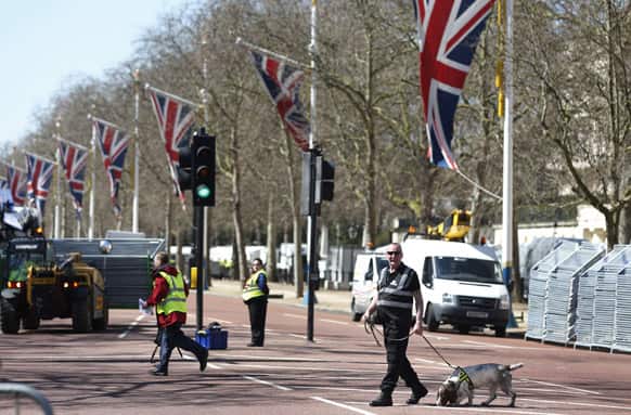 Security personnel use sniffer dogs to check vehicles at the Mall in central London, where the London Marathon finish line will be on Sunday, April, 21.