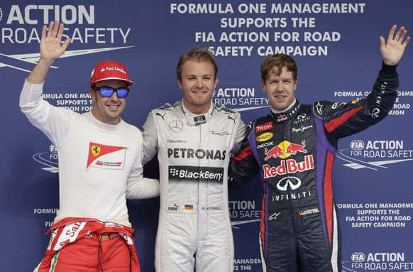 Mercedes driver Nico Rosberg of Germany who captured the pole position, second fastest time Red Bull driver Sebastian Vettel of Germany and Ferrari driver Fernando Alonso of Spain react after the qualifying session ahead of the Bahrain Formula One Grand Prix.