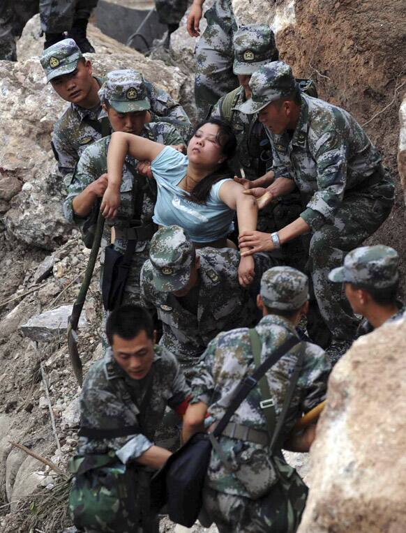Rescuers save an injured woman after an earthquake hit Baosheng Township in Lushan County, Ya`an City, southwest China`s Sichuan Province.