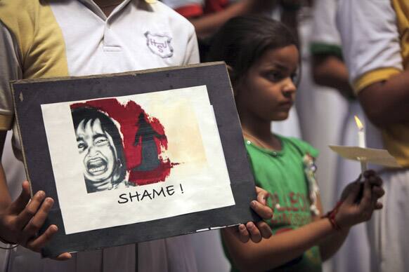 A schoolgirl participates in a candle-light vigil for the speedy recovery of a 5-year-old girl who was raped and tortured in Delhi, at Heritage School in Jammu.