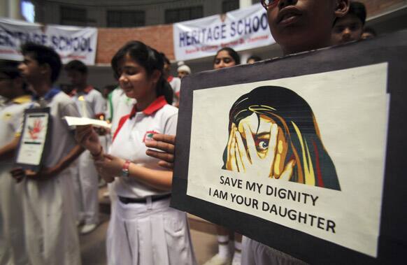 Students participate in a candle-light vigil for the speedy recovery of a 5-year-old girl who was raped and tortured in Delhi, at Heritage School in Jammu.