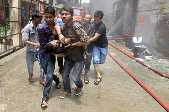 Volunteers rescue an injured man from a shopping mall that caught fire in Dhaka, Bangladesh. The fire was reportedly caused by a gas cylinder explosion.