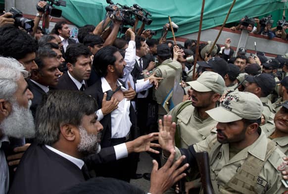 Pakistani paramilitary troops trying to control lawyers chanting anti-Musharraf slogans outside an anti-terrorism court, where former President and military ruler Pervez Musharraf is appearing in Islamabad.