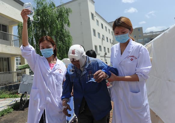 Nurses help an injured man at a temporary treatment station following an earthquake in Lushan county in Ya`an in southwest China`s Sichuan province.