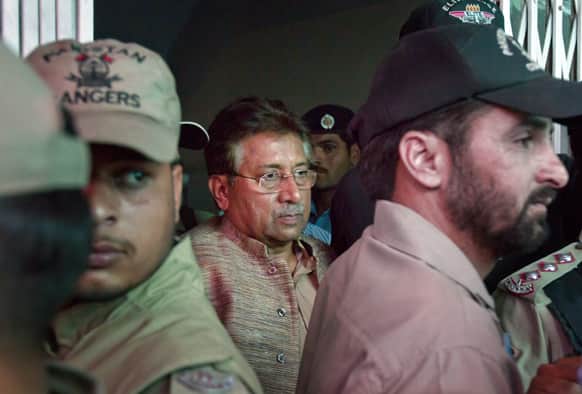 Paramilitary troops stand guard as Pakistan`s former President and military ruler Pervez Musharraf, center, leaves after appearing in an anti-terrorism court in Islamabad.