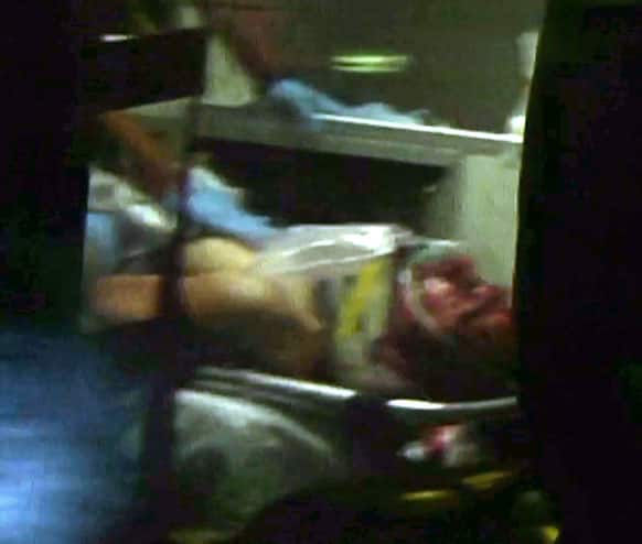 This still frame from video shows Boston Marathon bombing suspect Dzhokhar Tsarnaev visible through an ambulance after he was captured in Watertown, Mass.