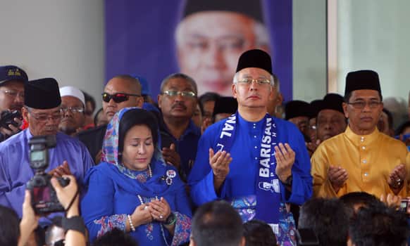 Malaysian Prime Minister Najib Razak and his wife Rosmah Mansor, offer prayers before leaving for an election nomination center in Pekan, Pahang state, Malaysia.