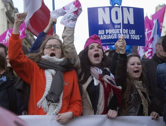 Demonstrators shout as they march during a rally to protest against French President Francois Hollande`s social reform on gay marriage and adoption at the Invalide square in Paris.