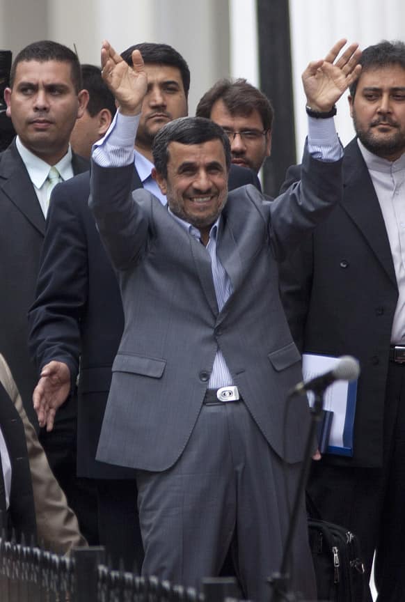 Iran`s President Mahmoud Ahmadinejad greets government supporters as he arrives to the Venezuelan Parliament to attend the swearing-in ceremony of President-elect Nicolas Maduro in Caracas, Venezuela.