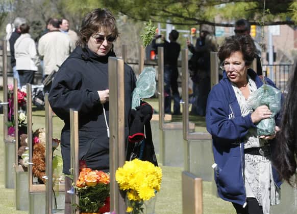 Lori Shulman, left, and Wendy Feinbert-Kotula, right,9-11 ambassadors, walk through the Field of Chairs at the Oklahoma City National Memorial in Oklahoma City.