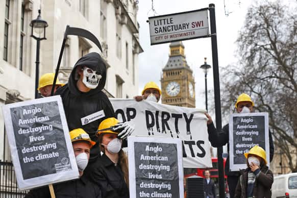 Protesters in miners` helmets, one dressed as Grim Reaper, holding banners and placards, demonstrate against British mining company Anglo-American, outside the conference center where the company`s annual AGM was taking place, in central London.