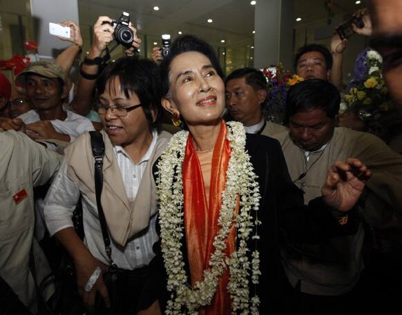 Myanmar opposition leader Aung San Suu Kyi is greeted by supporters at Yangon International Airport upon returning from Japan.