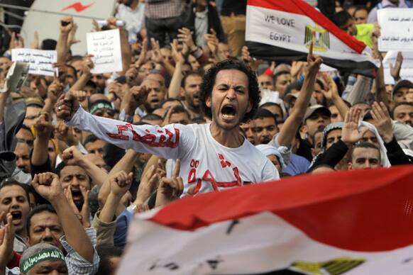 Egyptian Muslim Brotherhood members shout slogans during a protest in front of the Supreme Judicial Council in Cairo, Egypt.
