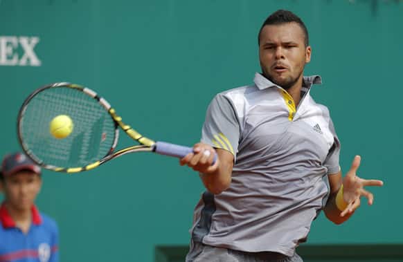 France`s Jo-Wilfried Tsonga plays a return to Stanislas Wawrinka of Switzerland during their quarter final match of the Monte Carlo Tennis Masters tournament in Monaco.