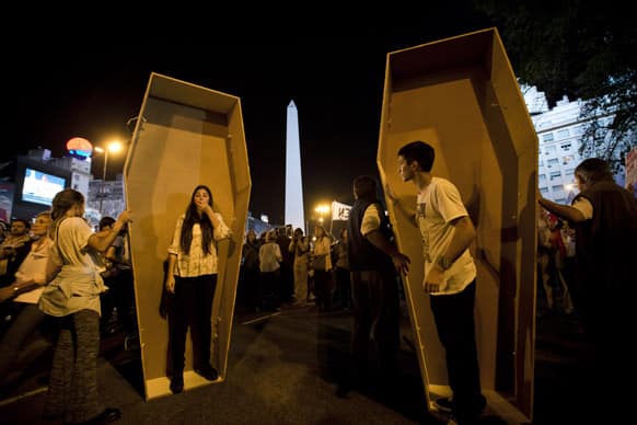 Protesters stand inside fake coffins during a march against the government of President Cristina Fernandez in Buenos Aires, Argentina. Angry about corruption, inflation and crime, thousands took the streets of Argentina`s capital in the year`s biggest anti-government protest.