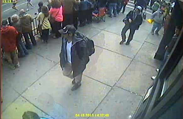 This image released by the FBI shows a image from video what the FBI are calling suspect number 1, front, in black cap, and suspect number 2, in white cap, back right, walking near each other through the crowd in Boston on Monday, April 15, 2013, before the explosions at the Boston Marathon.