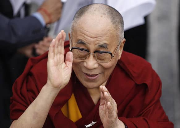 Exiled Tibetan spiritual leader the Dalai Lama greets people after walking over the Londonderry Peace Bridge, during a visit to Londonderry, Northern Ireland.