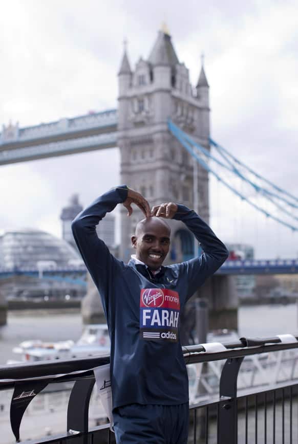British runner Mo Farah, the reigning Olympic 5,000 and 10,000 meter distance champion poses for photographers during a media opportunity backdropped by Tower Bridge in London.