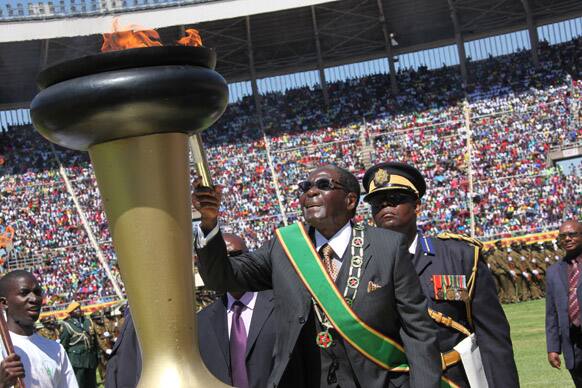 Zimbabwe`s President Robert Mugabe lights the independence flame during Zimbabwe`s 33rd independence celebrations in Harare.