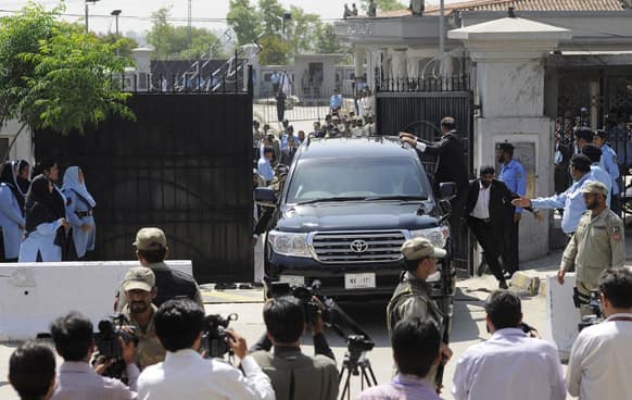 Pakistan`s former President and military ruler Pervez Musharraf leaves the High Court in Islamabad, Pakistan. Musharraf and his security team pushed past policemen and sped away from a court.